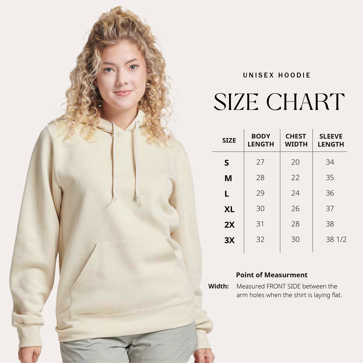 woman is wearing cozy cream fleece hoodie and a size chart next to