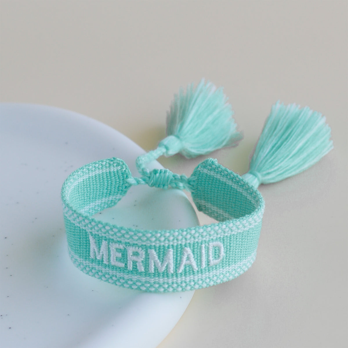 disney-parks-fan-woven-tassel-bracelet-mermaid-teal-white-embroidery