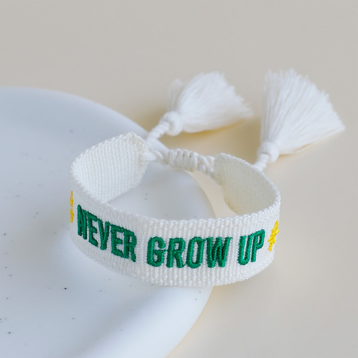 disney-parks-fan-woven-tassel-bracelet-never-grow-up-white-green-embroidery